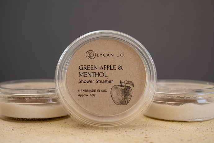 Packaged LycanCo Green Apple & Menthol Shower Steamer showcasing its crisp, fruity aroma for a revitalizing shower.