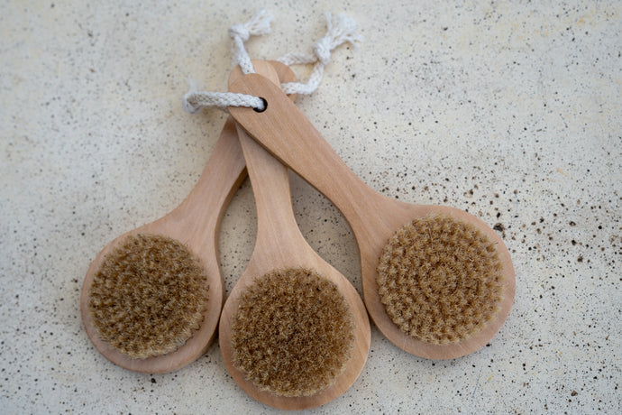Image of three LycanCo natural scrub brushes with wooden handles and stiff bristles, suitable for thorough cleansing.